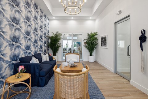 a living room with a blue and white wallpaper and a blue couch